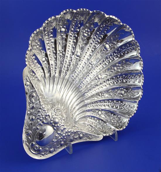 A late Victorian repousse silver scallop shaped dish, 10 in.